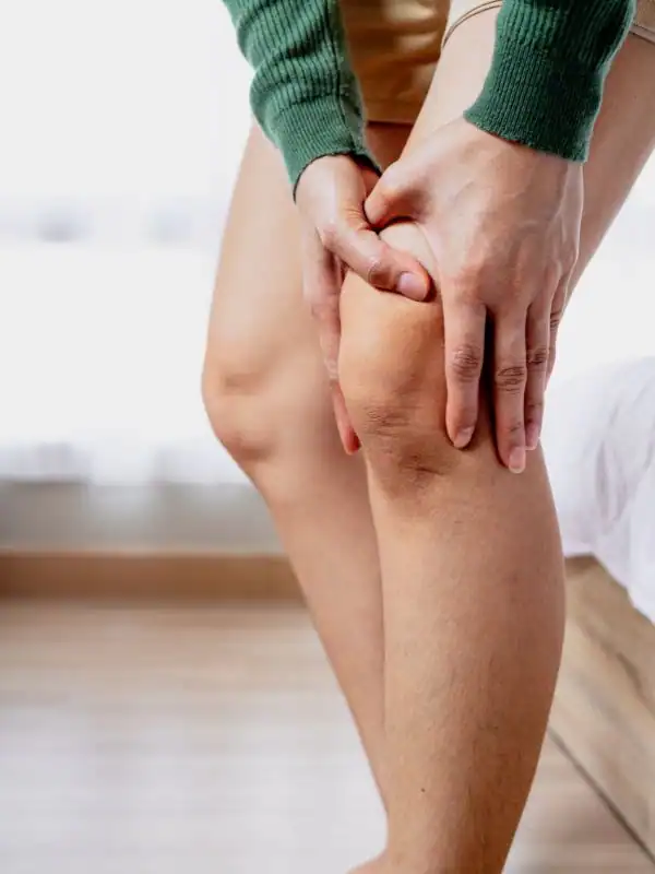 Woman clutching her knee in pain