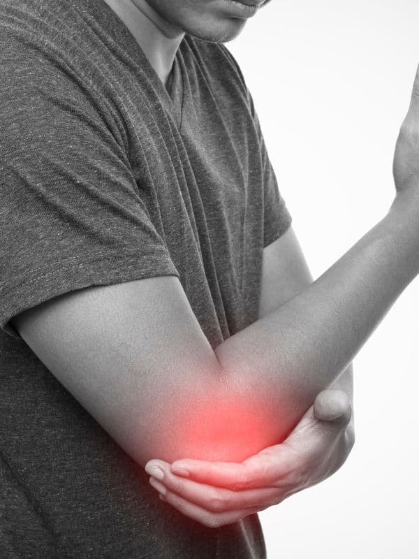 Person wincing and holding their outer elbow